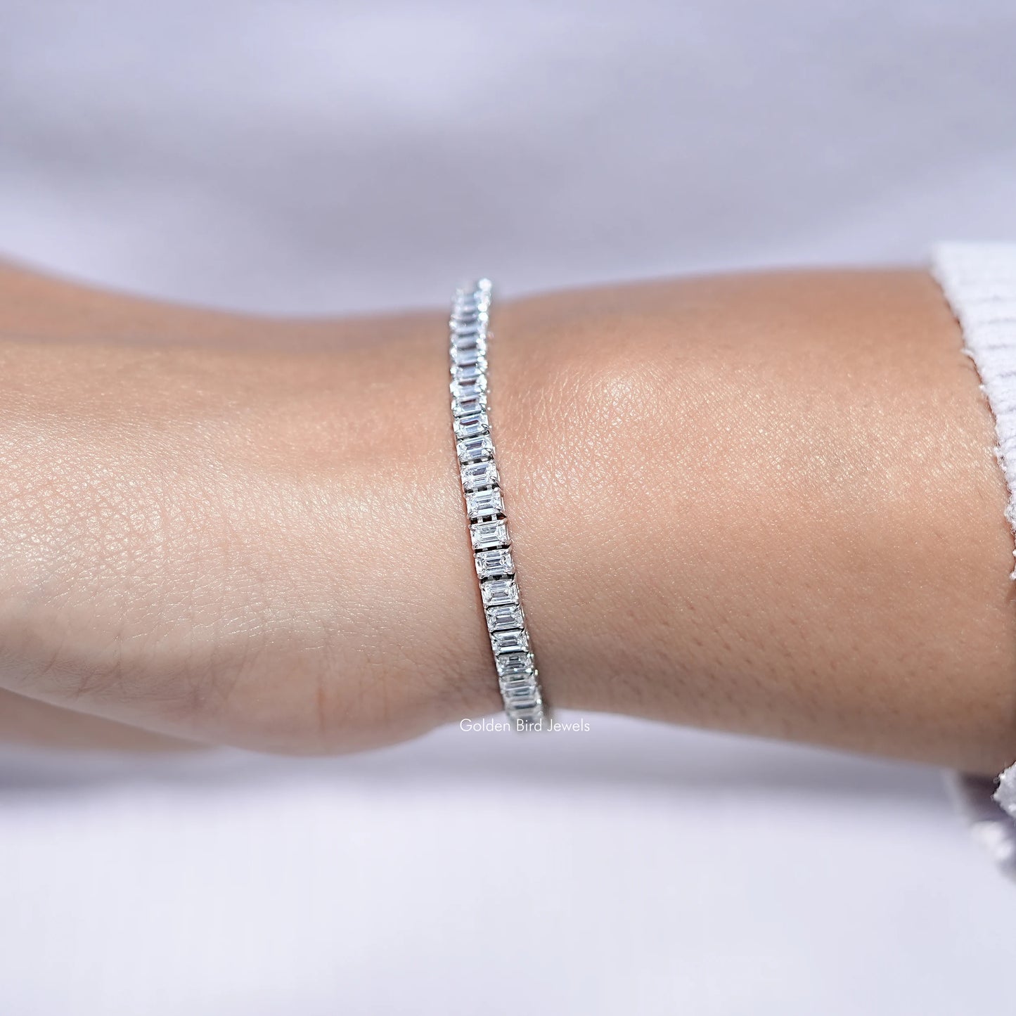 In hand Showing View Of Emerald Cut Lab Diamond Tennis Bracelet