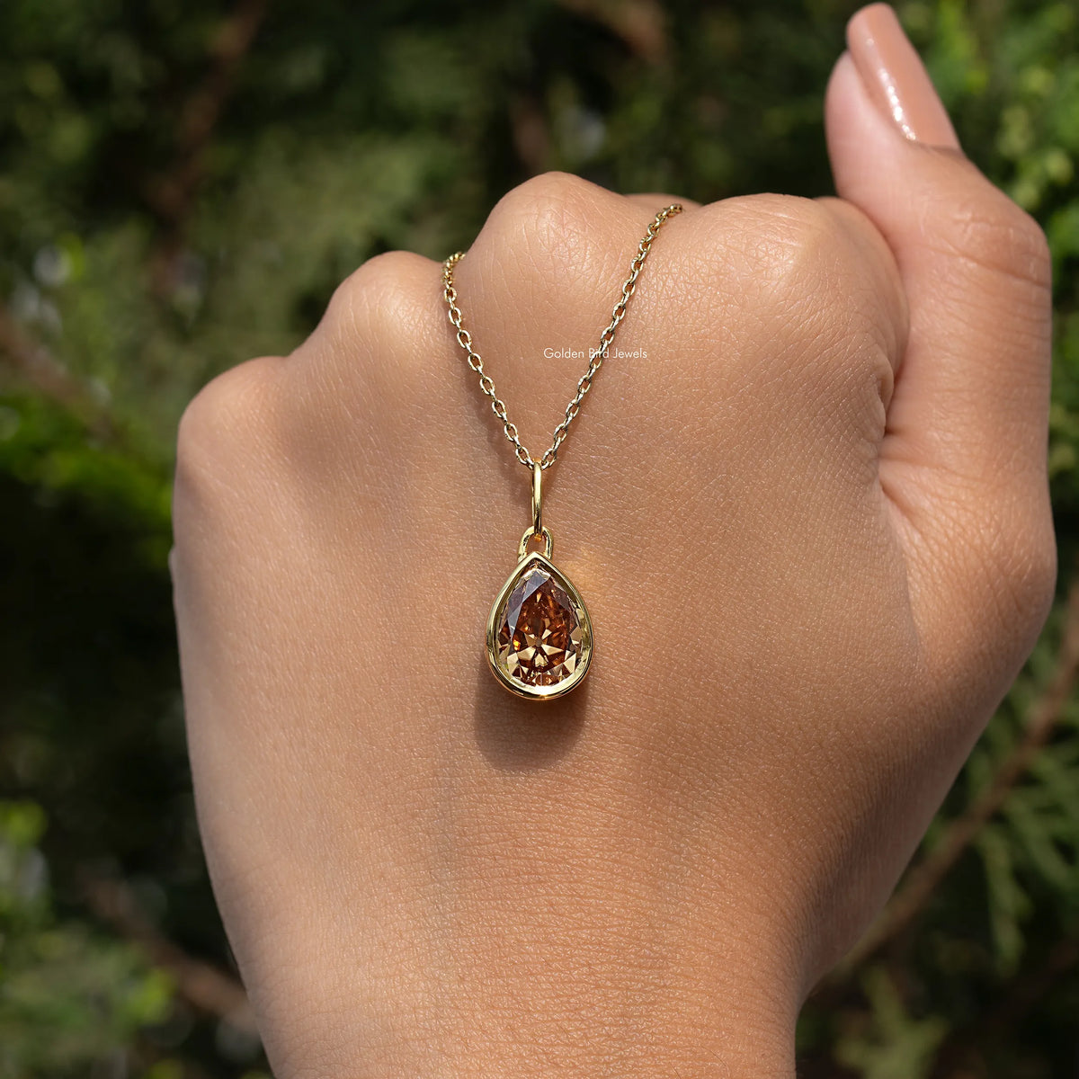 In hand Showing View Of Old Mine Pear Moissanite Pendant