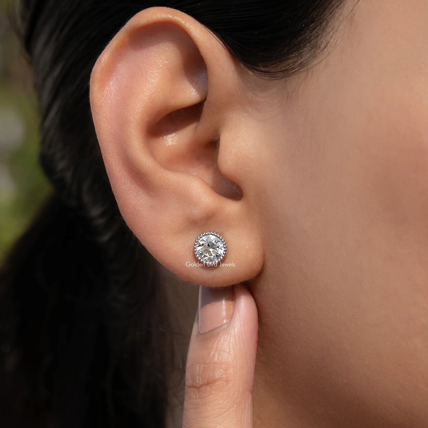 Detailed view of Old European Round Stud Earrings in secure setting