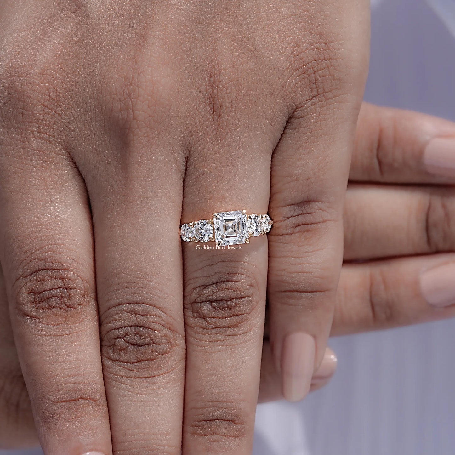 Top view of Asscher Cut Lab Diamond Five Stone Ring Held in Finger