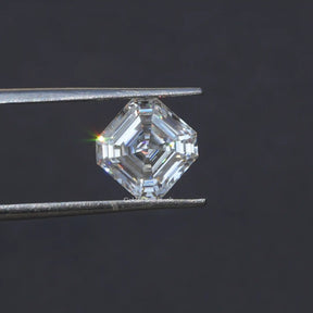 Tweezers holding the  Moissanite Asscher Cut Loose Stone