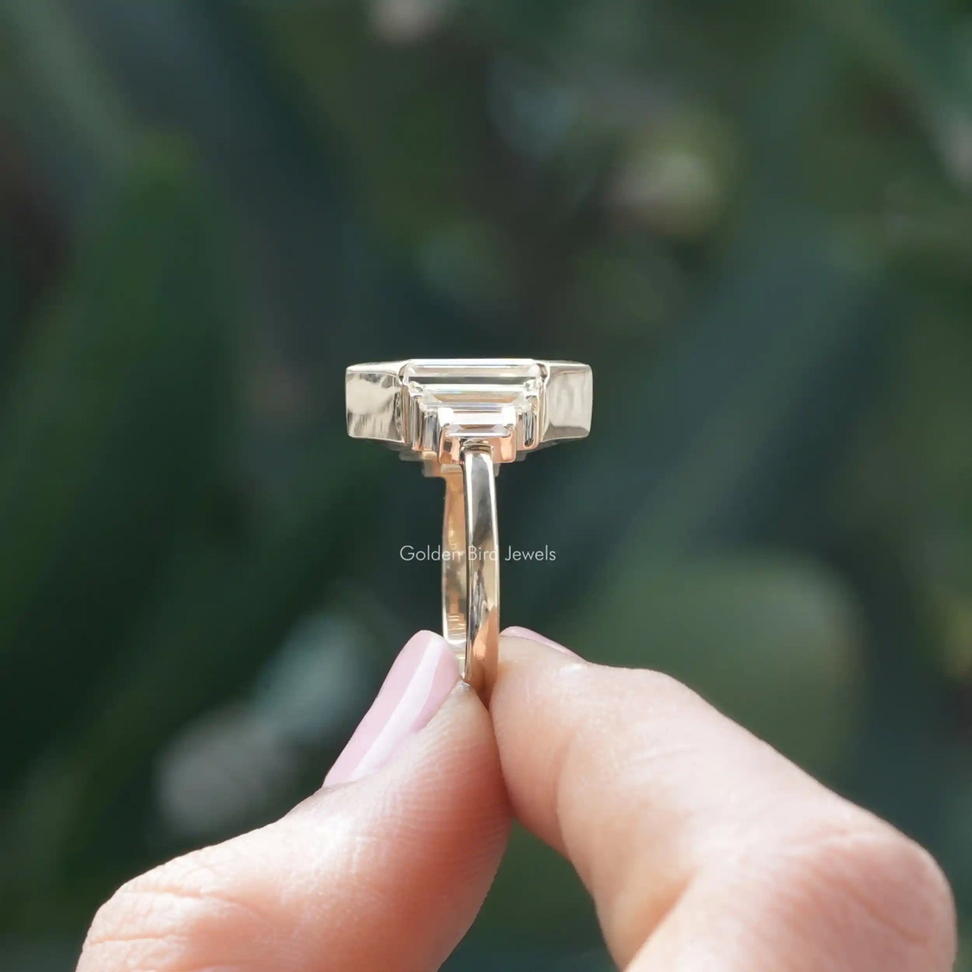 Side View of Baguette Cut Moissanite Engagement Ring In two fingers