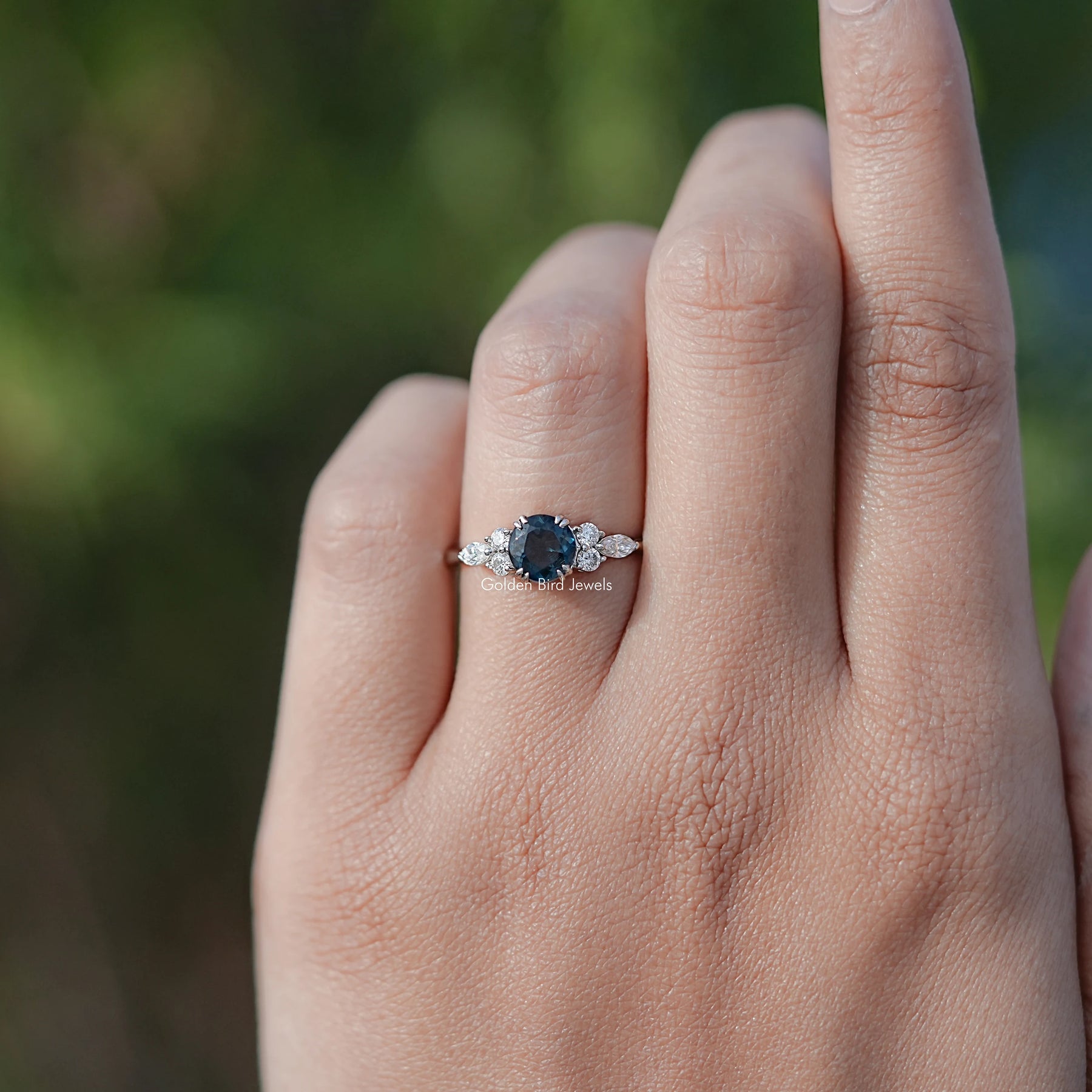 In finger view of Blue Topaz Round Gemstone Accent Stone Ring