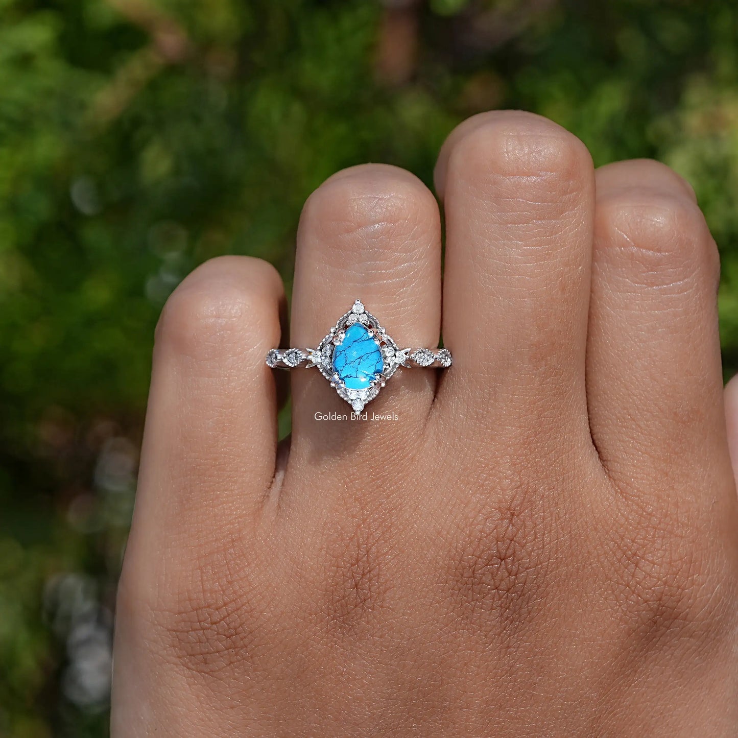Detailed View of Pear Cut Gemstone Accent Ring In White Gold