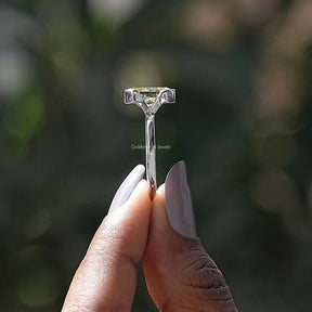 Side View of Radiant Cut Moissanite Solitaire Ring In two fingers