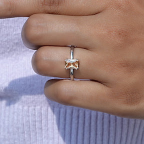 Detailed View of Orange Emerald Cut Gemstone Ring In White Gold