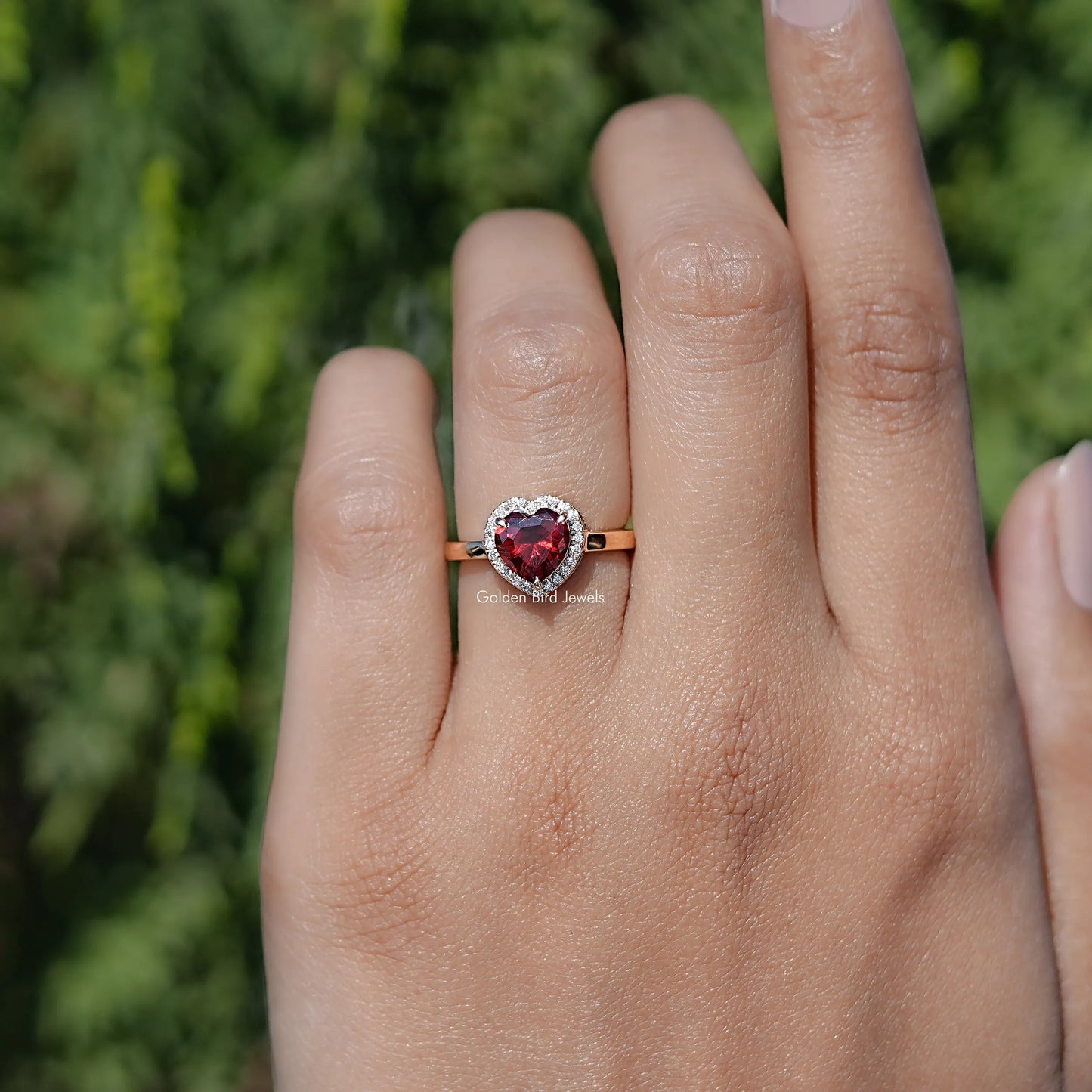 In finger front view of Red Ruby Heart engagement ring 

