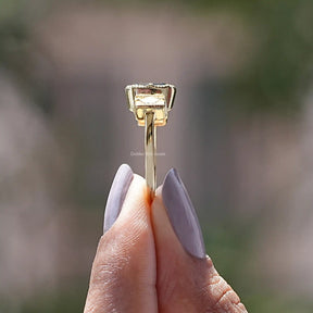 Side View of Old Mine Criss Cut Three Stone Ring In two fingers