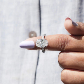 In finger front View of Ice Oval Cut Moissanite Hidden Halo Ring In White Gold