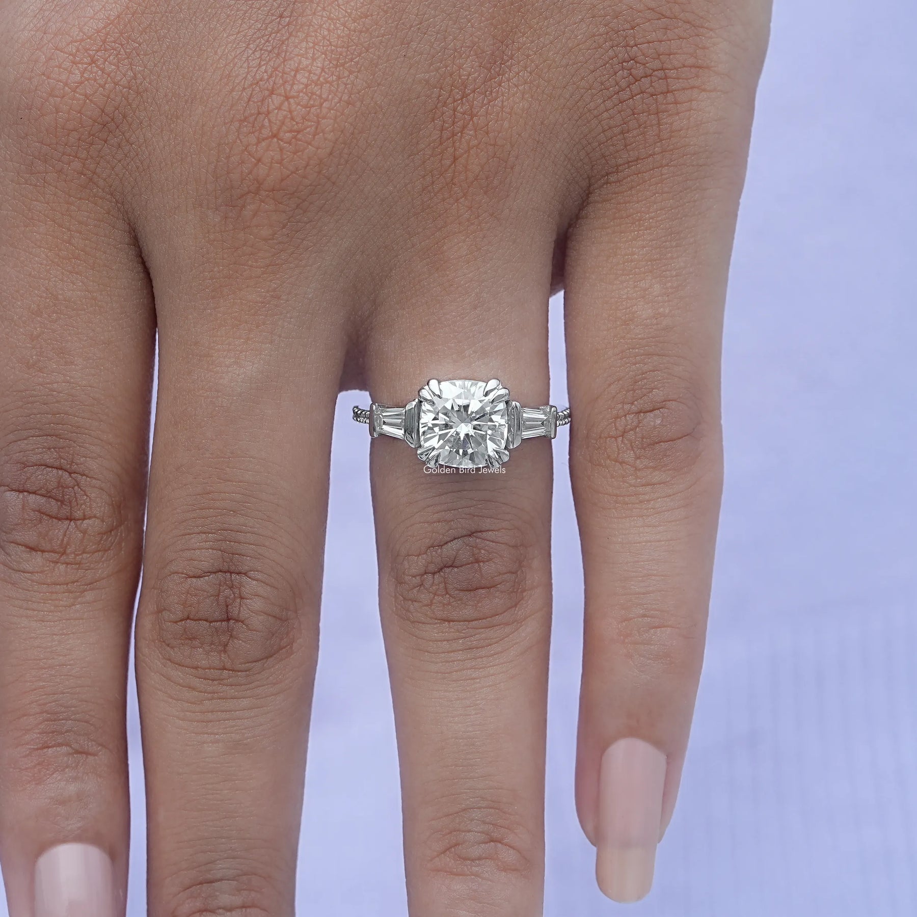 Close-Up View of Cushion Cut Three Stone Engagement Ring In White Gold