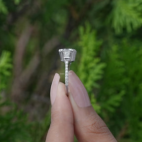 Side View of Moissanite Three Stone Engagement Ring In two fingers