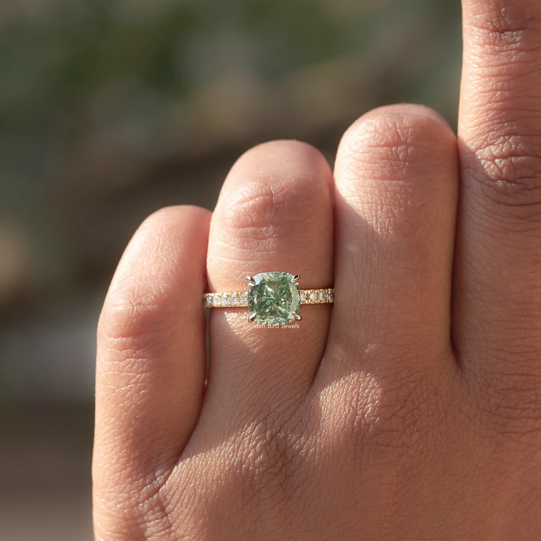 Detailed View Of Green Cushion Cut Moissanite Engagement Ring In Yellow Gold