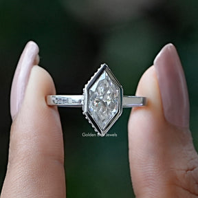 Two fingers holding the Marquise Cut Moissanite  Engagement Ring