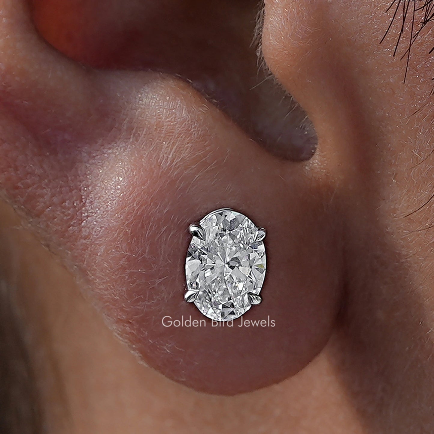 Close Up View Of Oval Cut Diamond Solitaire Stud Earrings