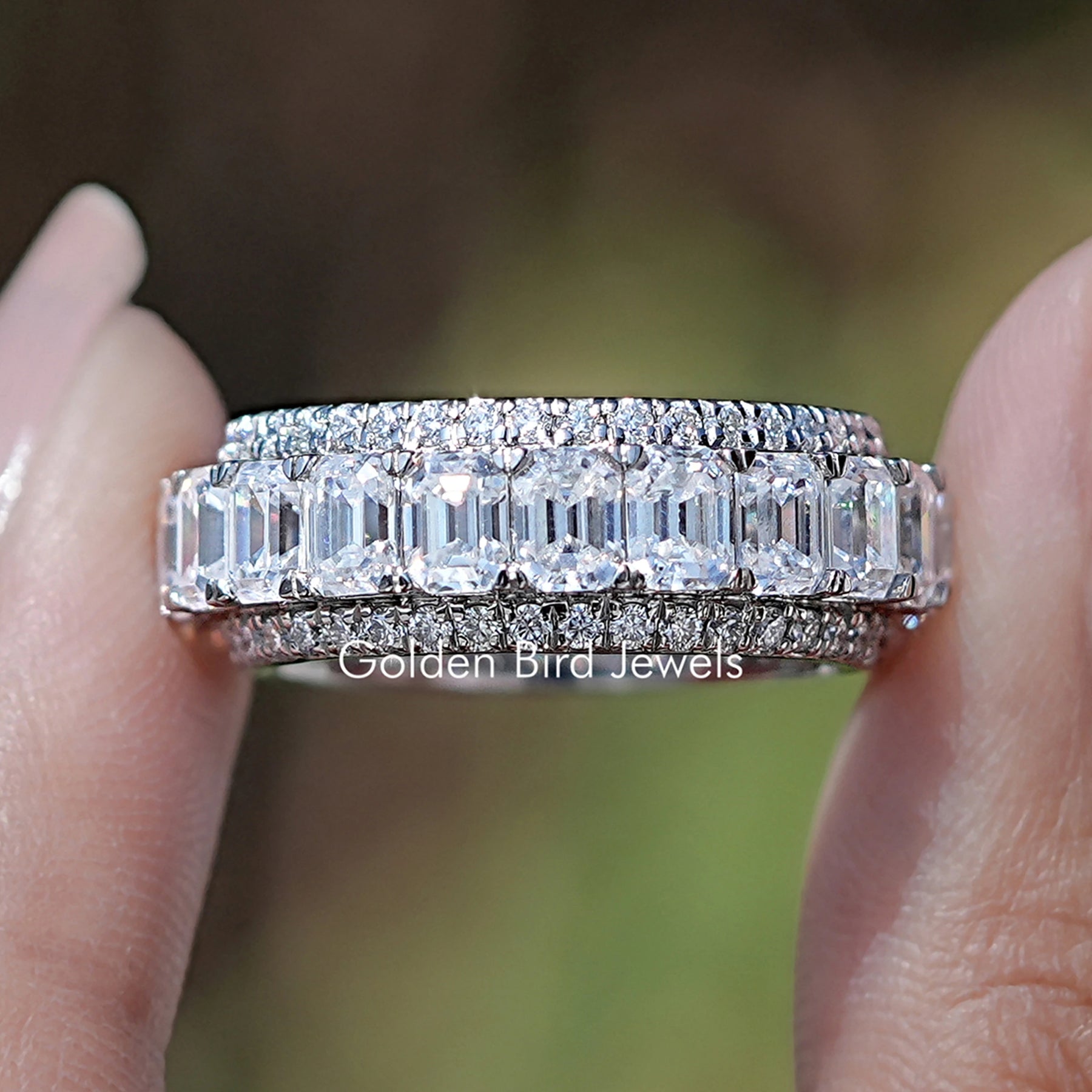 Front view of Emerald And Round Moissanite Three Row Wedding Band