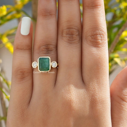 View of Emerald And Round Cut Moissanite Ring In Finger