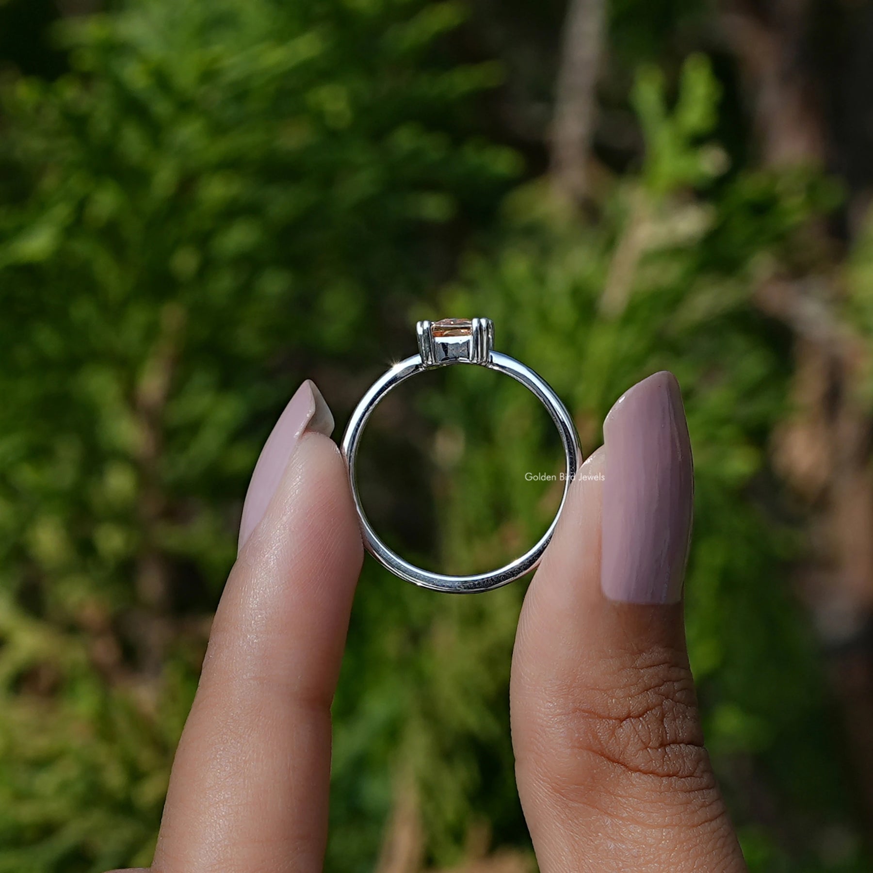 Back View of Citrine Orange Emerald Cut Gemstone Ring In two fingers