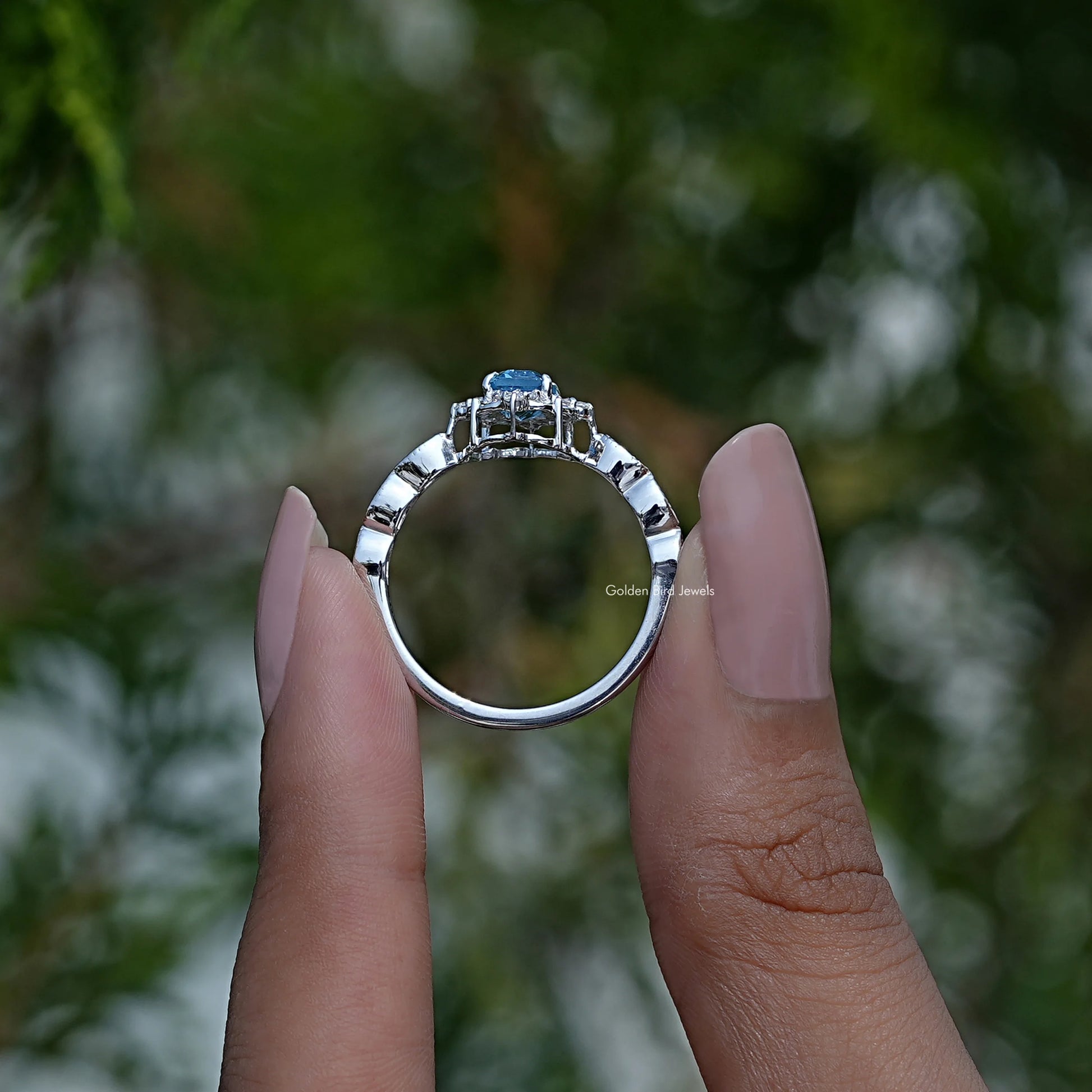 Back View of Emerald Cut Engagement Halo Ring In two fingers