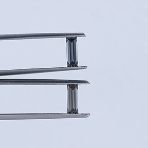 In Tweezer View Of Grey Baguette Cut Loose Moissanite Pair
