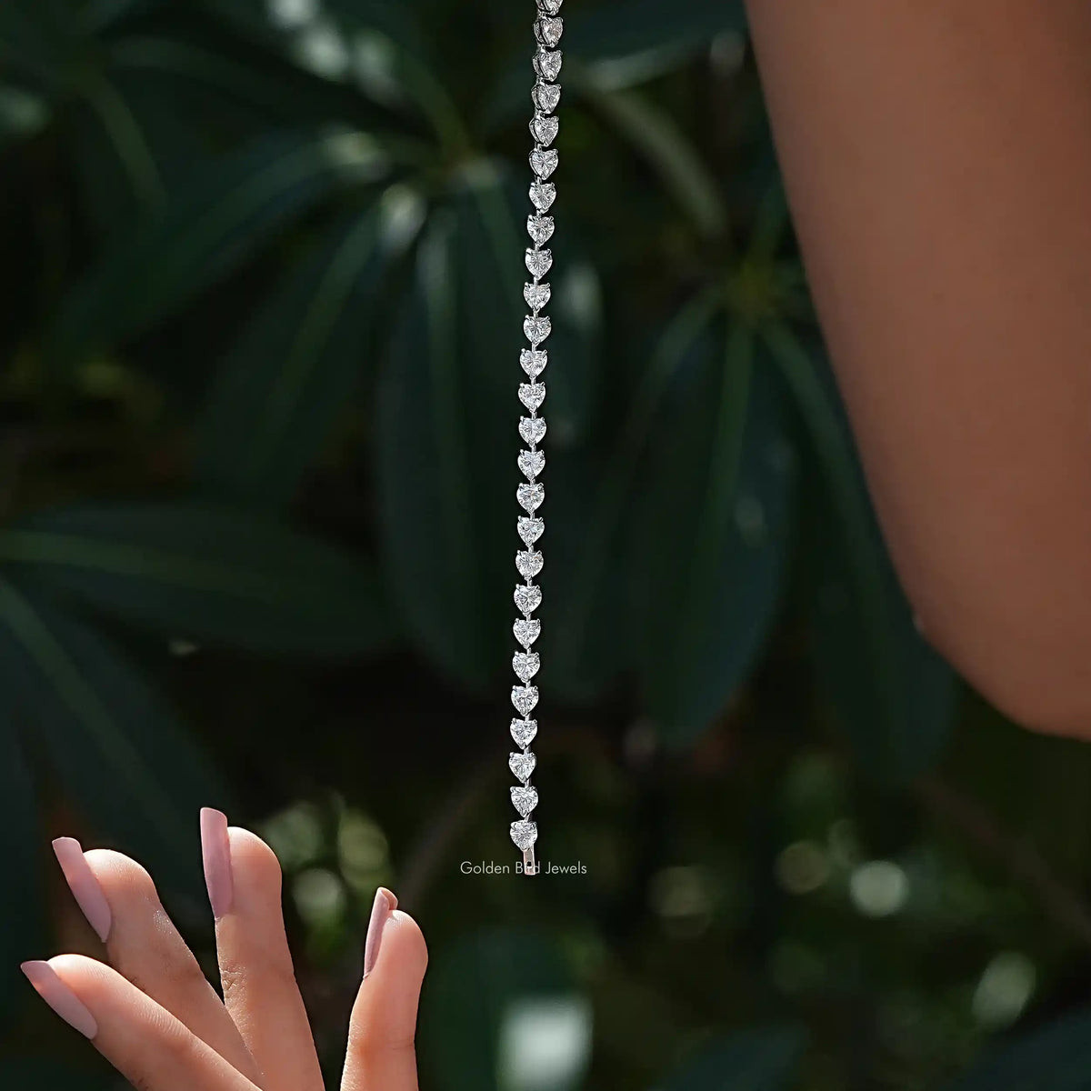 In-hand view of Heart moissanite halo bracelet 
