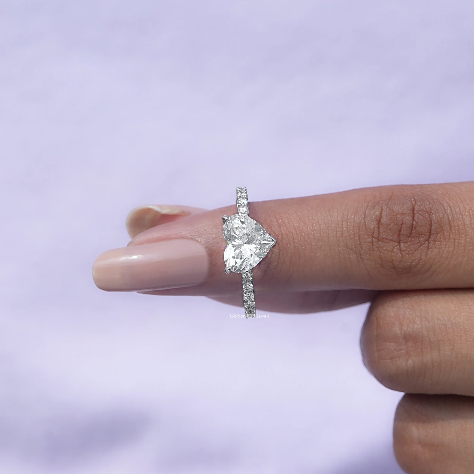 In finger front View of A Heart Cut Diamond Solitaire Ring In White Gold