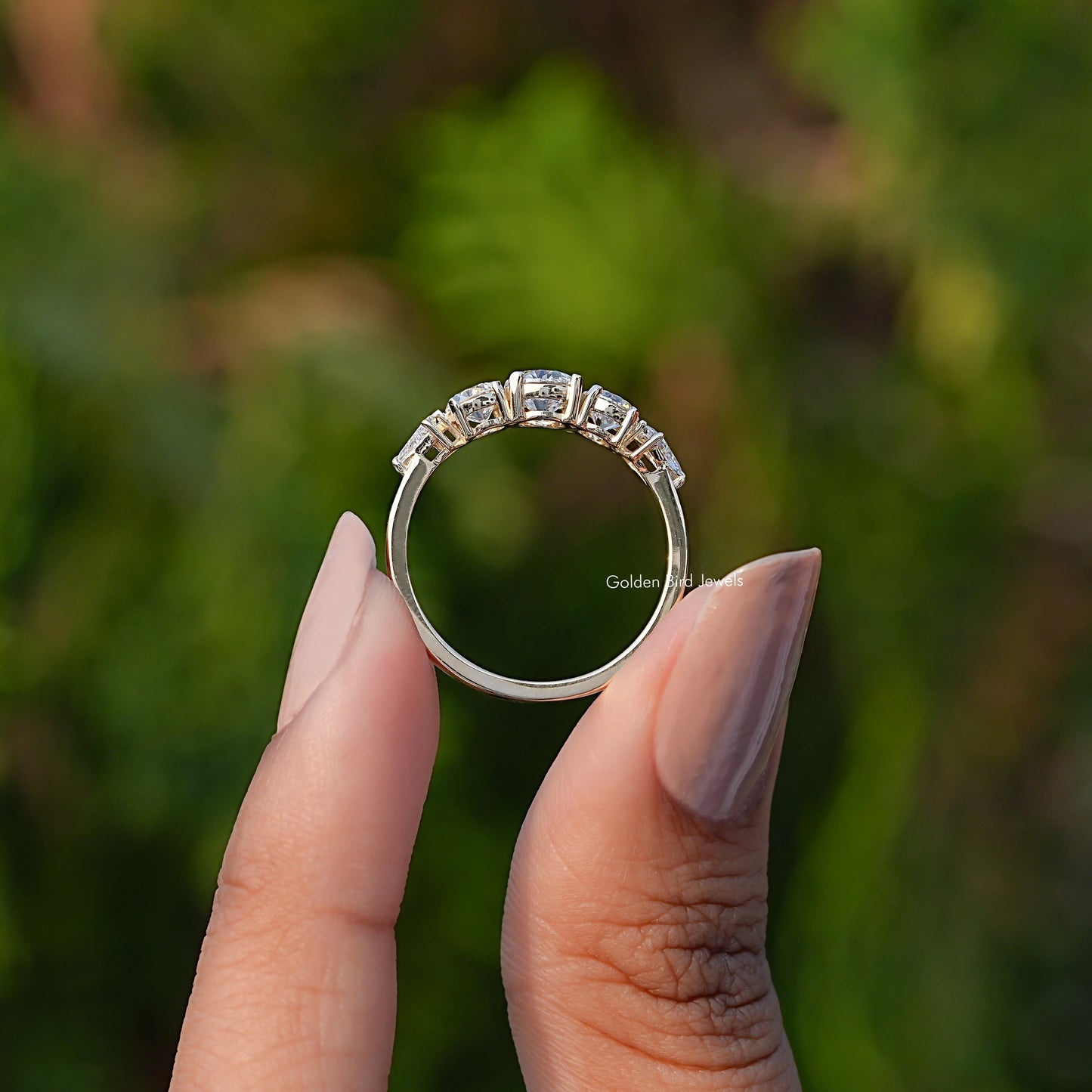 Back View of Round Cut Lab Grown Diamond Five Stone Ring In two fingers