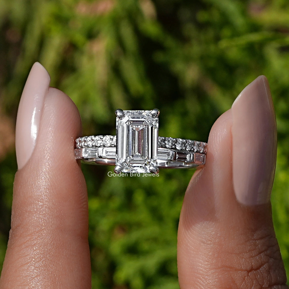 Lab Grown Diamond Emerald Cut Bridal Ring held between two fingers
