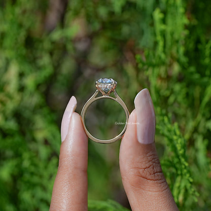 Back View of Cushion Cut Diamond Halo Engagement Ring In two fingers