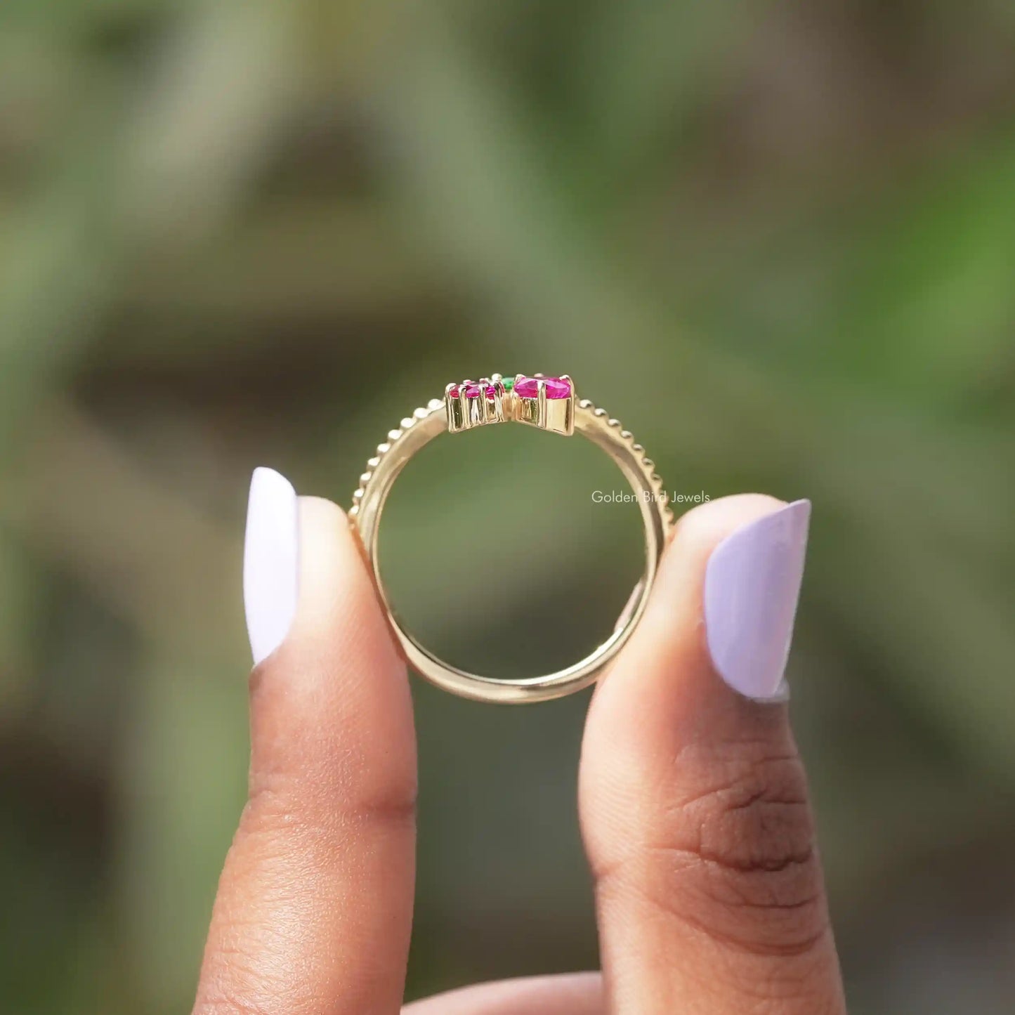 Back View of Heart Cut And Round Gemstone Ring In two fingers