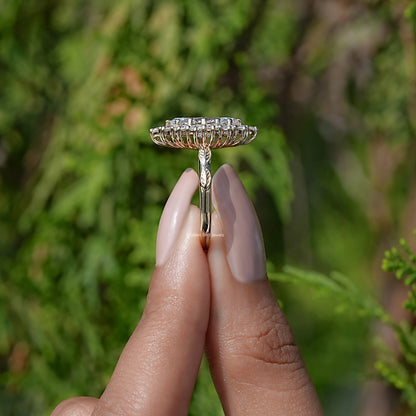 Side View of Marquise Cut Lab Diamond Halo Engagement Ring In two fingers