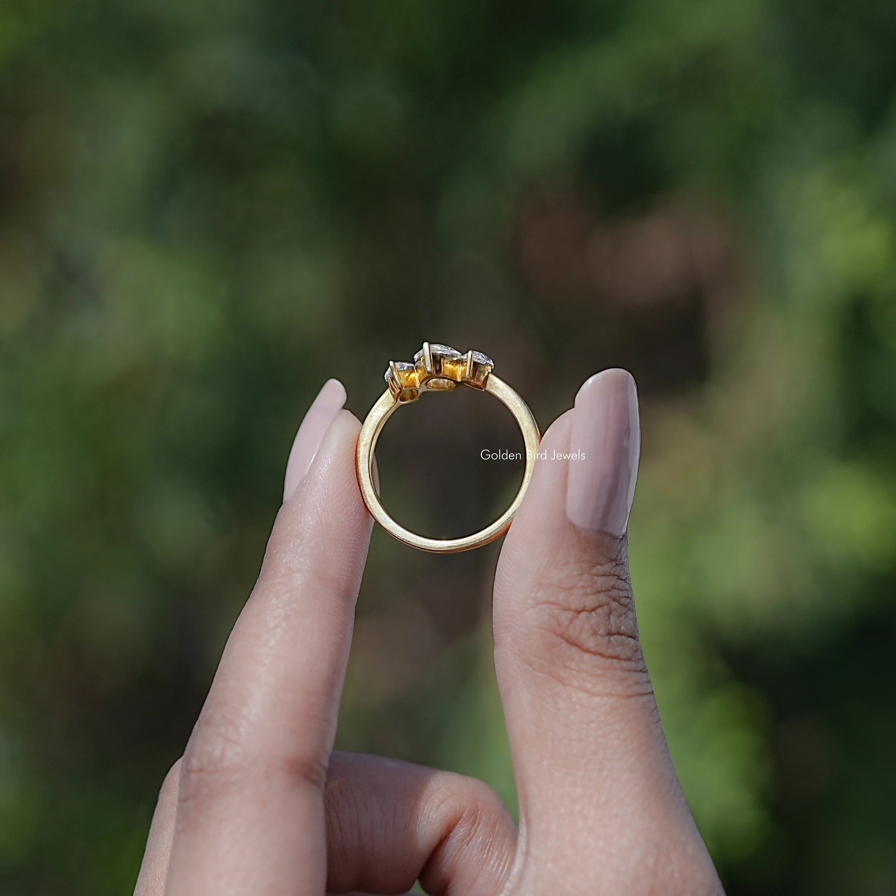 Back view of Marquise Moissanite Three Stone Engagement Ring Set in secure setting
