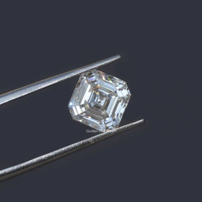 Tweezers holding the Colorless Asscher Cut Loose Moissanite