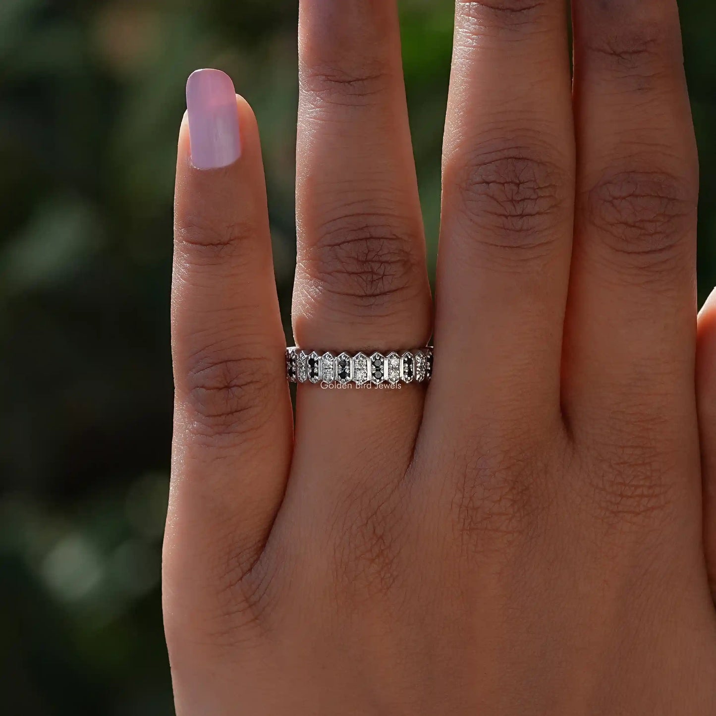 In finger front View of Colorless Round Cut Moissanite Band In White Gold