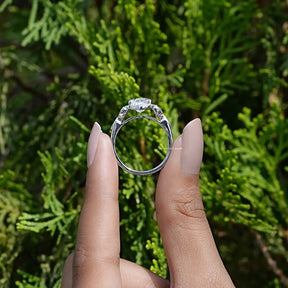 Back View of Moissanite Crushed Ice Oval Accent Ring In two fingers