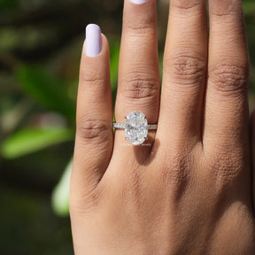 View of Oval And Round Cut Hidden Halo Moissanite Ring In finger