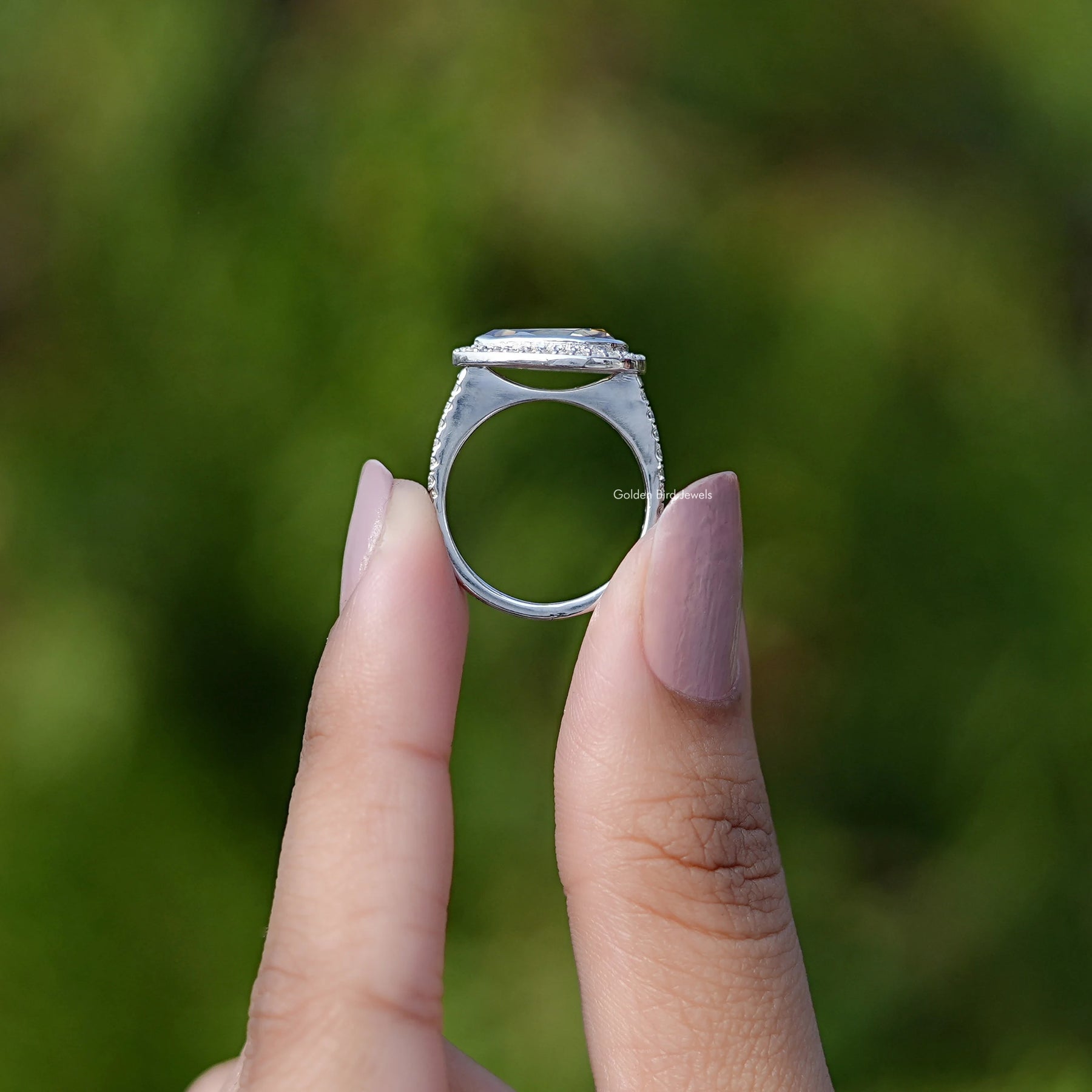 Back View of Pear Cut Moissanite Halo Ring In two fingers