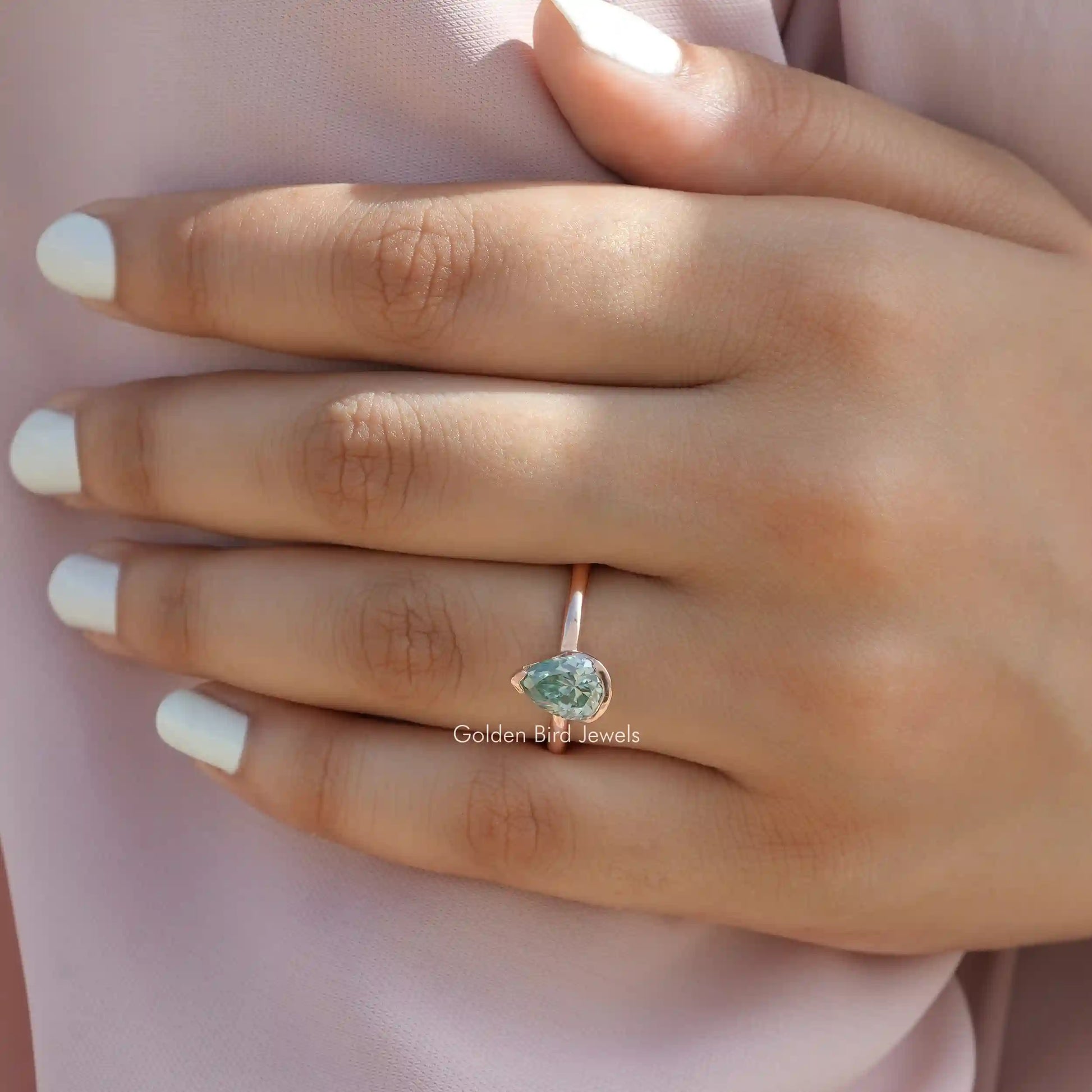 Close-Up View of Pear Cut Moissanite Engagement Ring In Yellow Gold