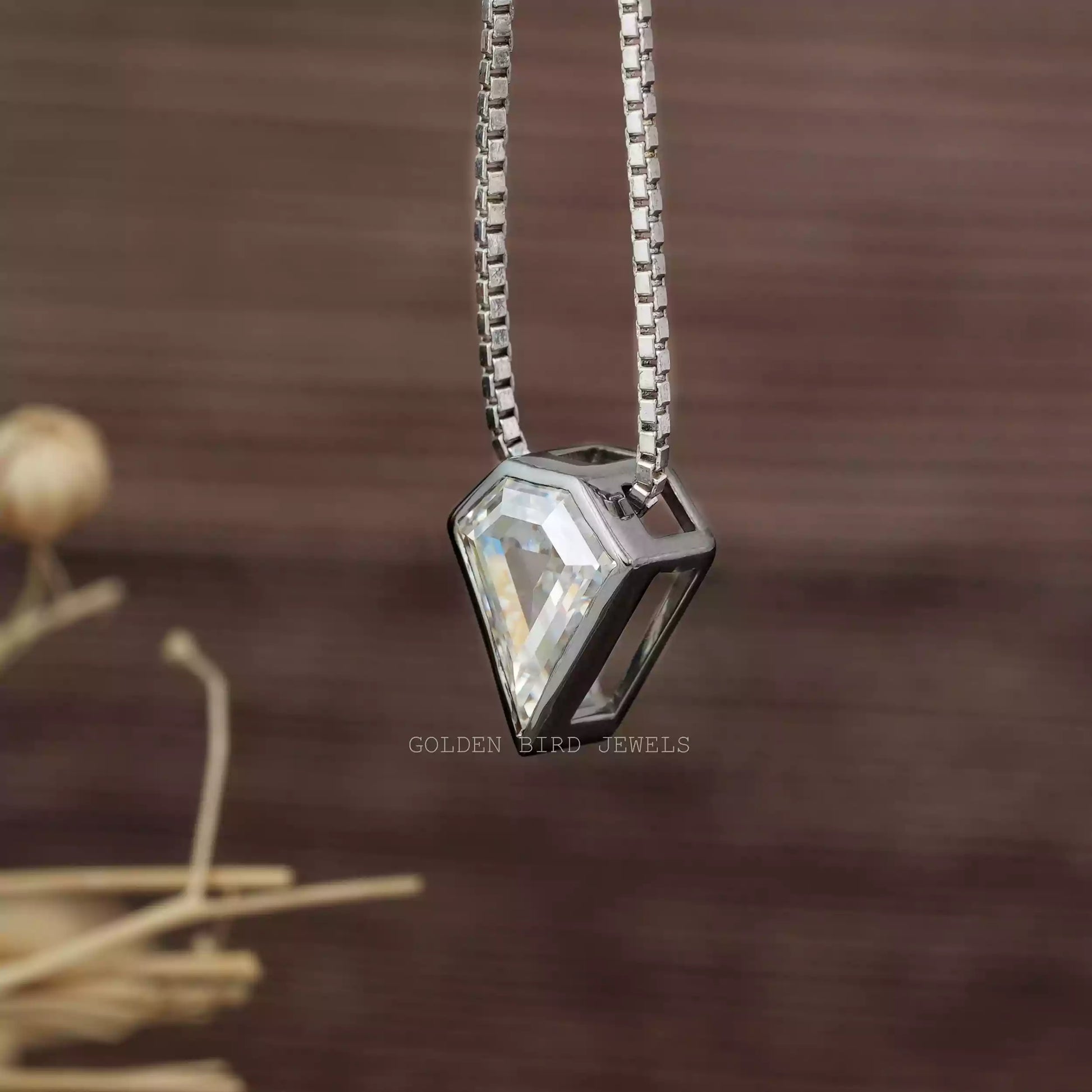 Side view of colorless pentagon cut pendant set in bezel setting