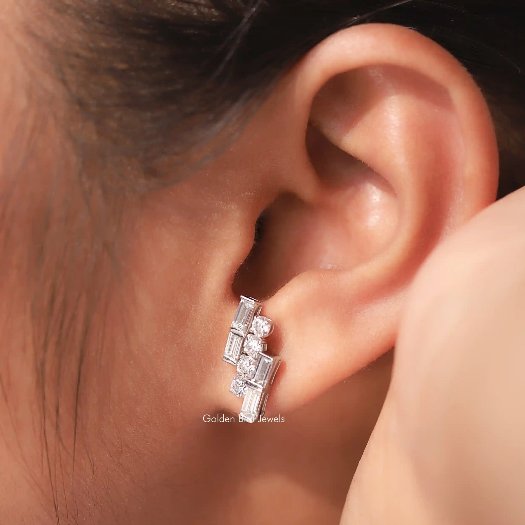 In Ear view of round and baguette Cut moissanite Stud Earrings 