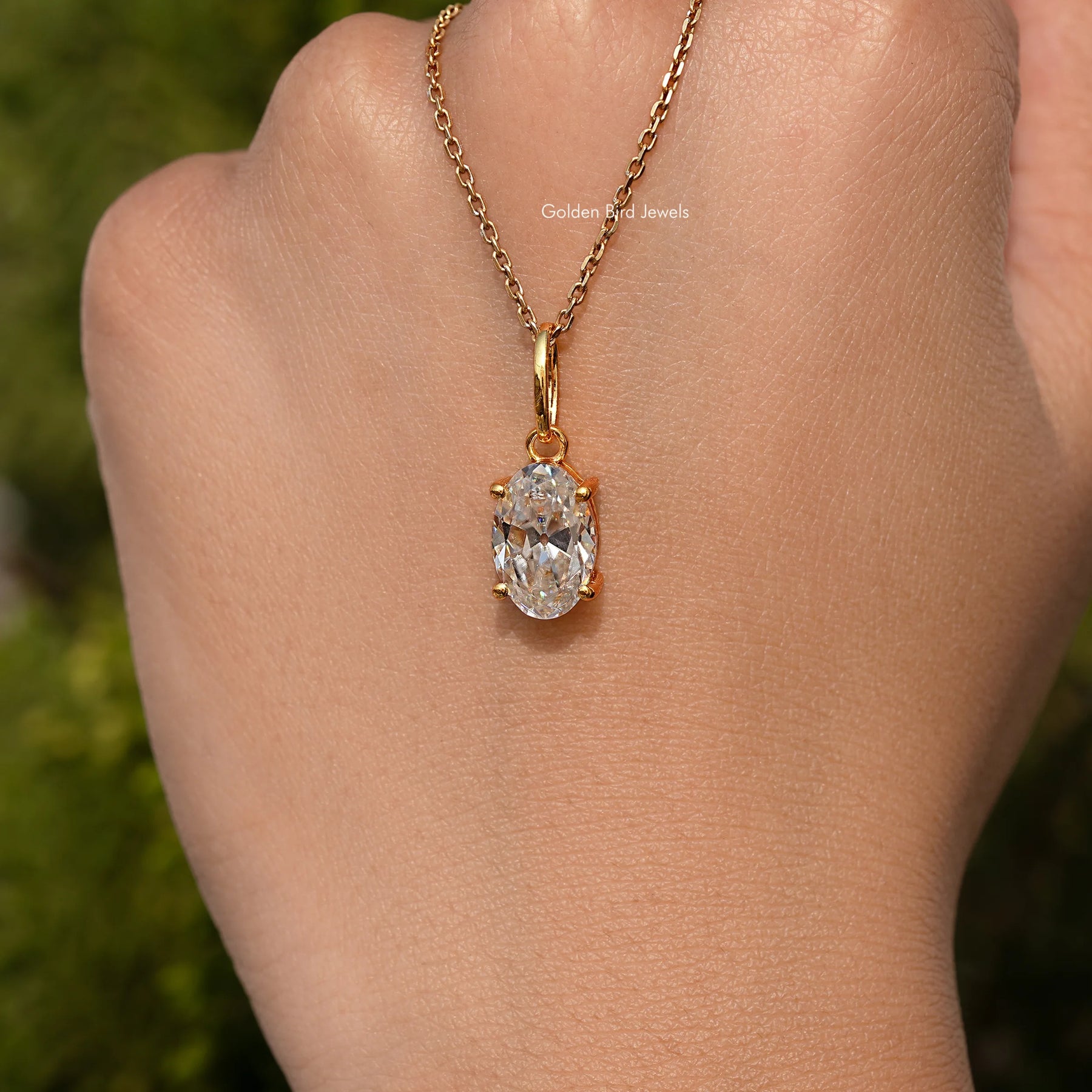 In hand Showing View Of Old Mine Oval Moissanite Pendant 