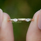Marquise Cut Lab Diamond Open Cuff Two Stone Ring Held Between Fingers