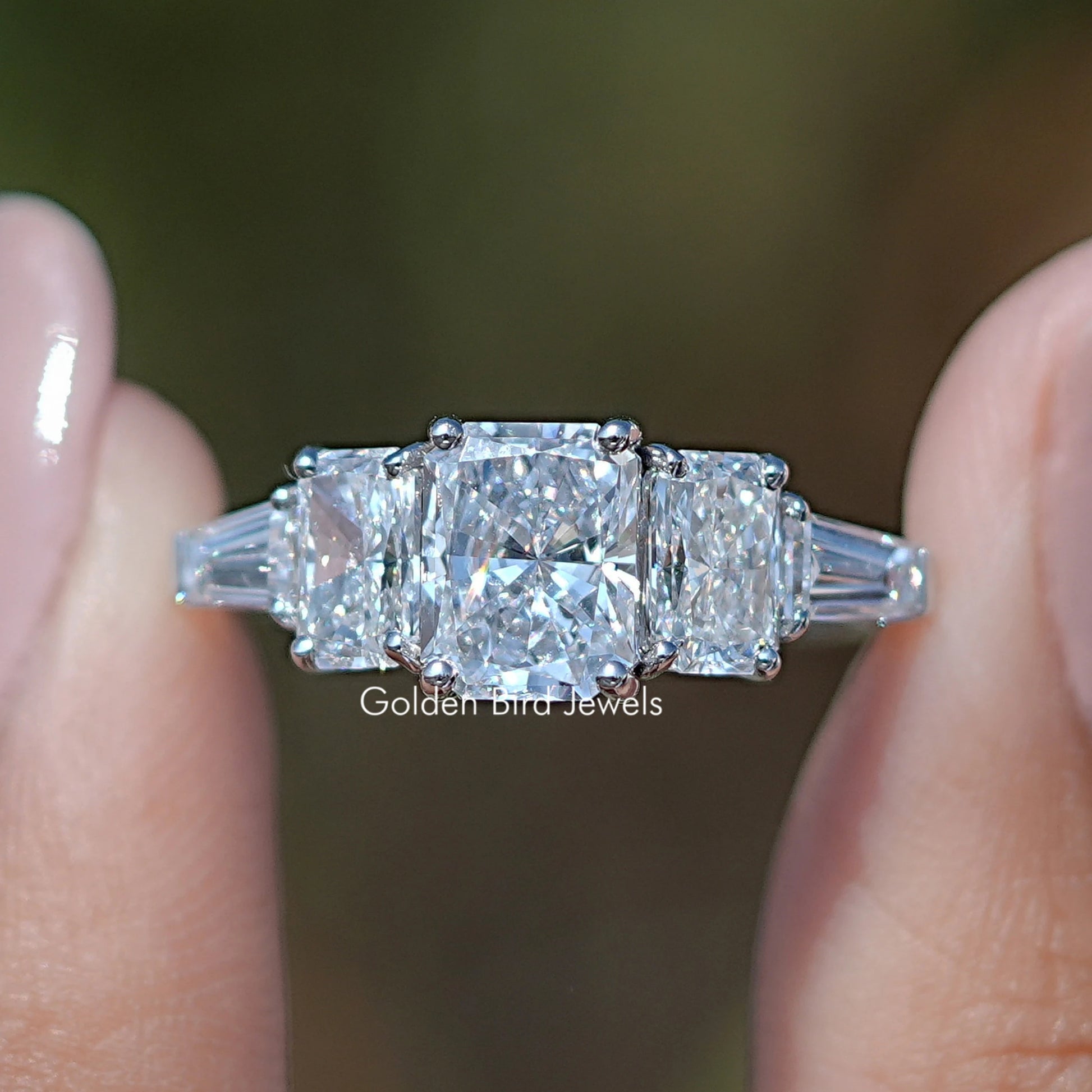 Radiant Cut Lab Diamond Five Stone  Ring Held Between Fingers