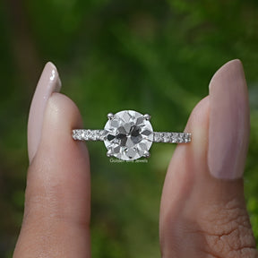 Two fingers holding the Old European Round Cut Diamond Ring