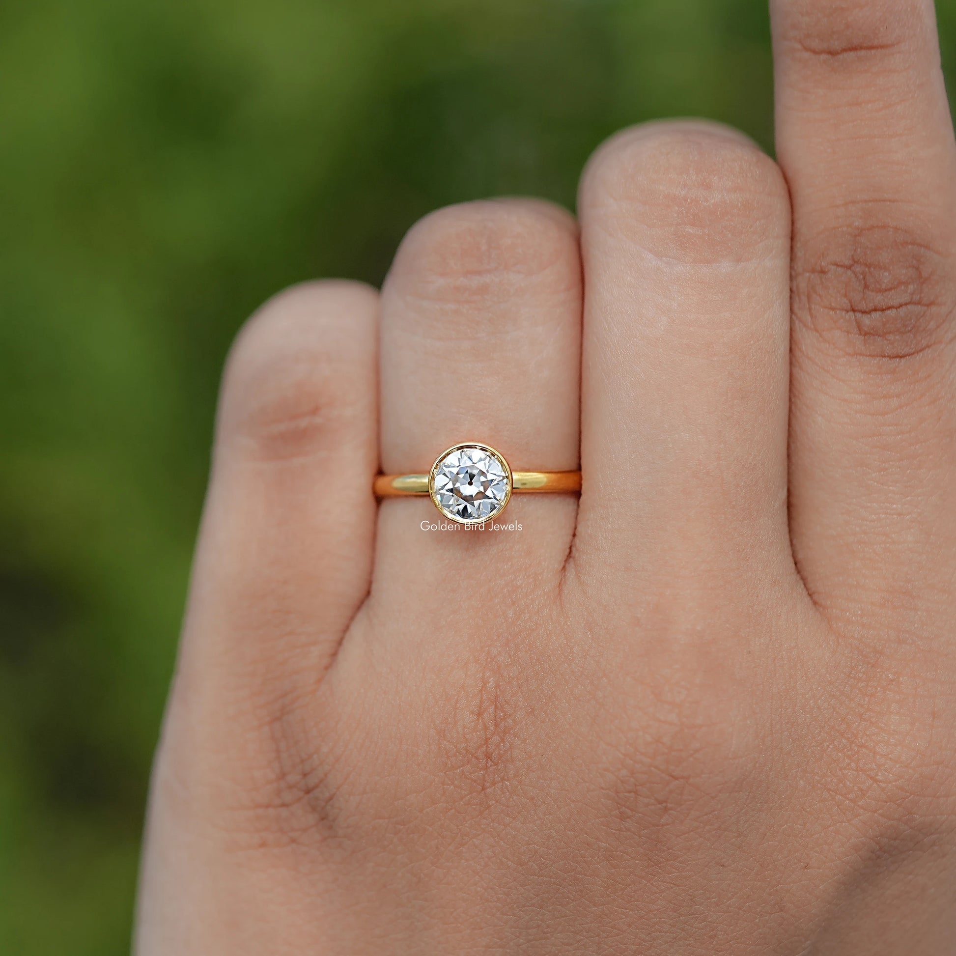 In finger view of Round Cut Solitaire Engagement Ring