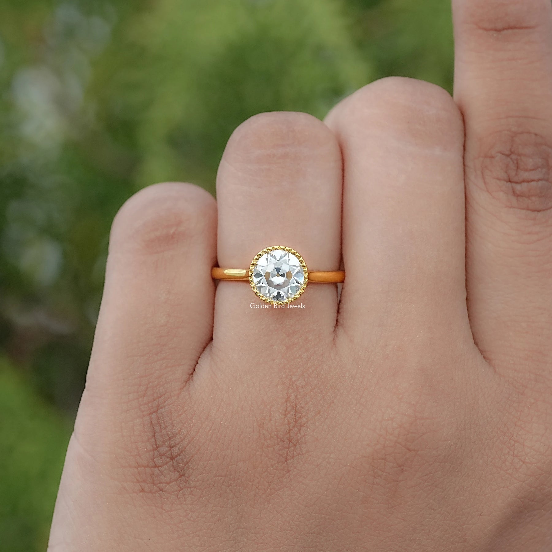 In finger view of Round Cut Solitaire Engagement Ring