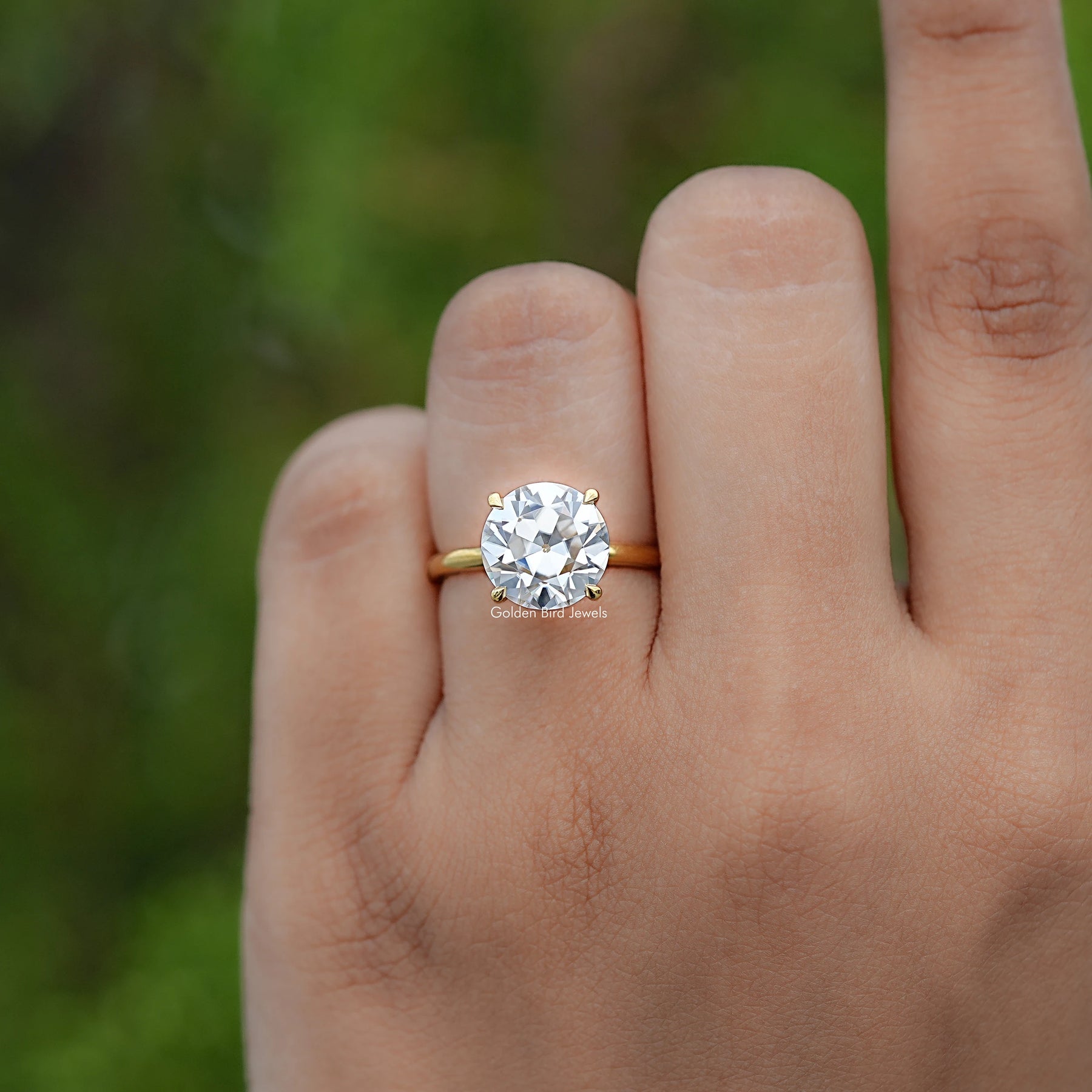 In finger view of Round Cut Solitaire Engagement Ring