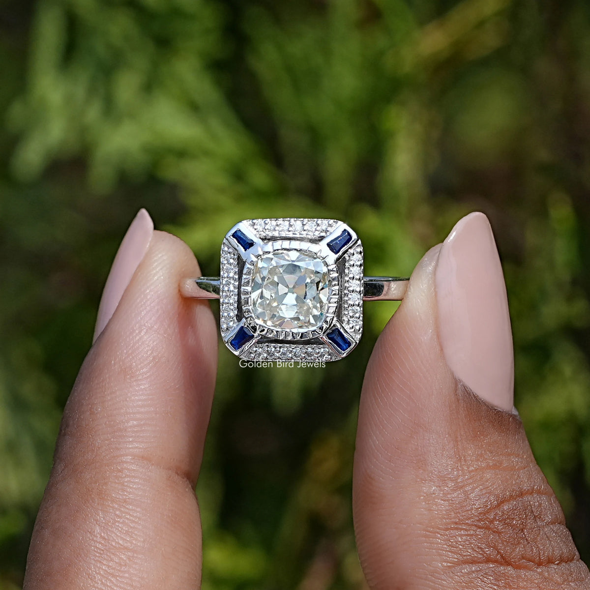 Front View of Old Mine Cushion Cut Moissanite Halo Ring In two Fingers