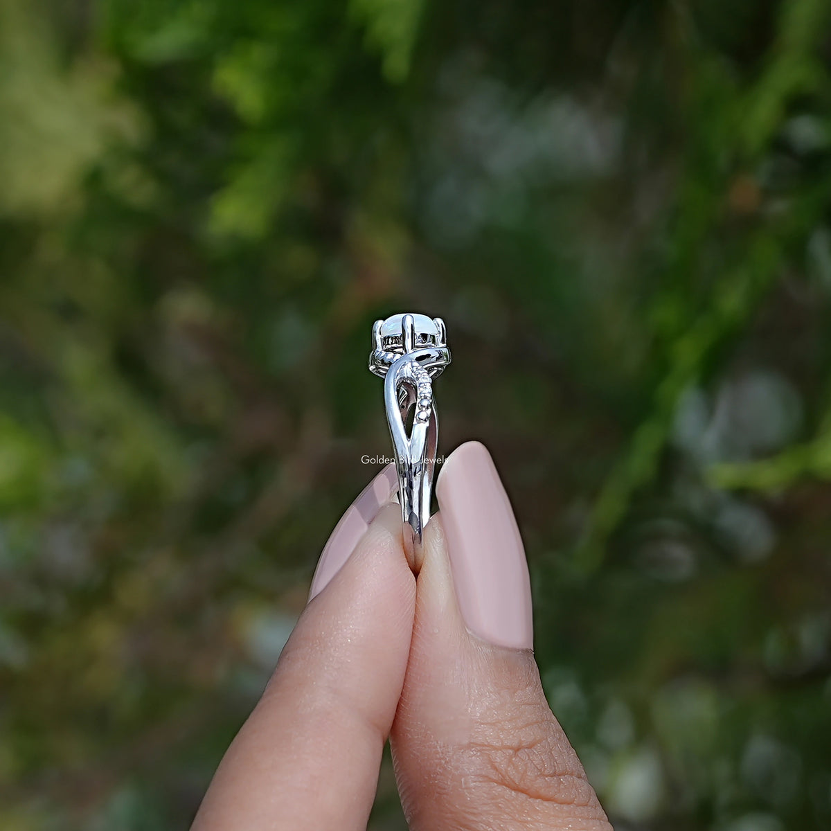 Side View of Opal Round Cut Gemstone Ring In two fingers