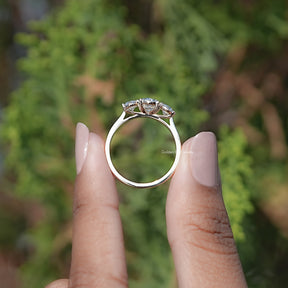 Back view of Oval Cut Lab Diamond Three Stone Ring Held in Finger