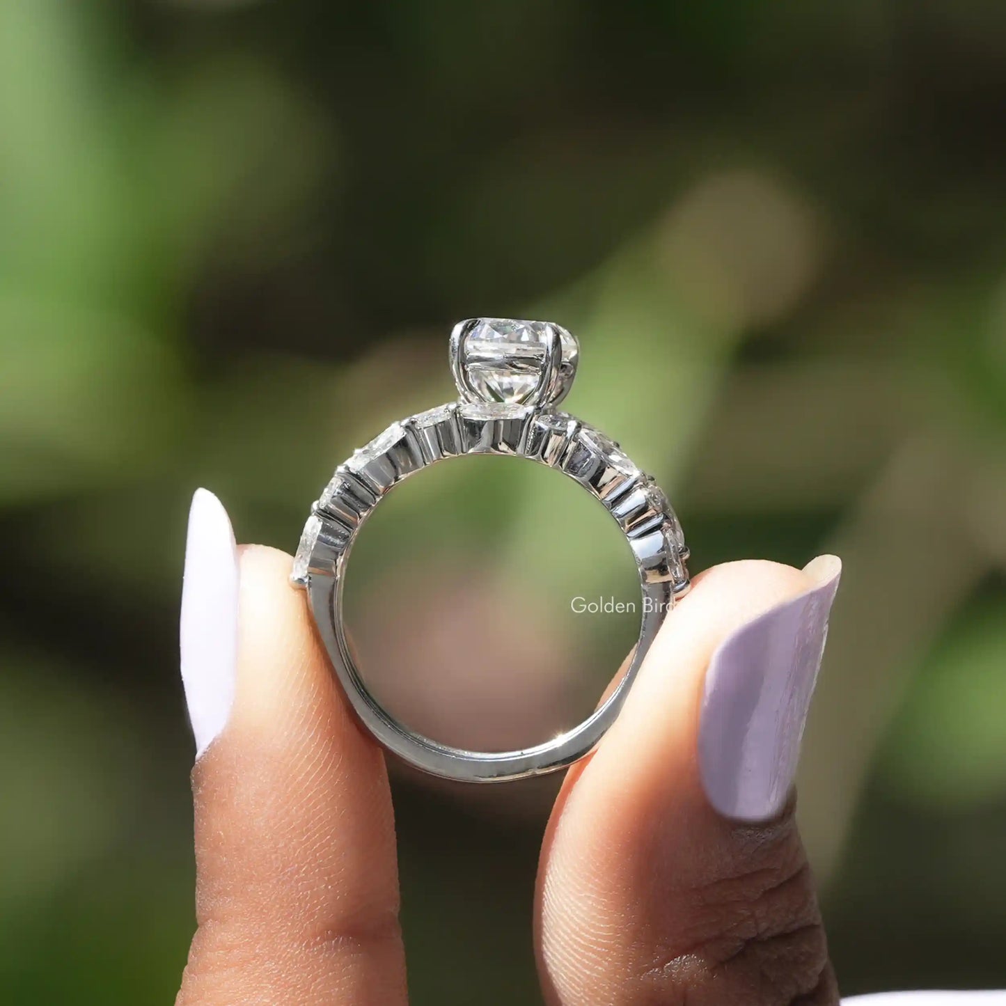 Back View of Moissanite Oval Cut Bridal Ring Set In two fingers